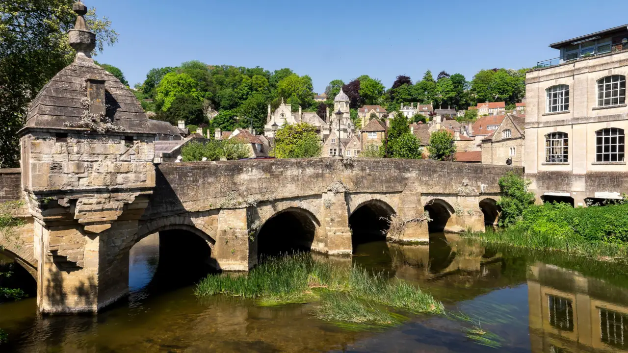 Charming stone bridge over river in sunny Bradford-on-Avon, England.