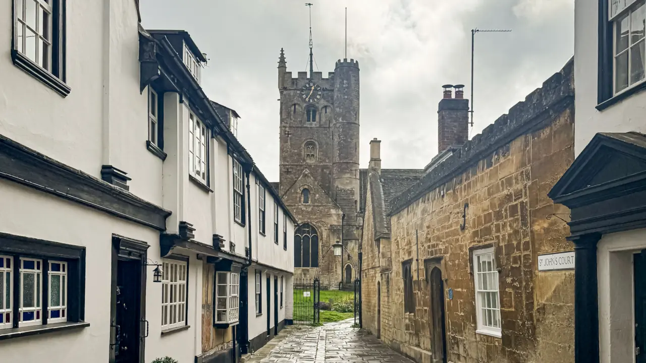 Charming cobbled street leading to an ancient church in Devizes, England.