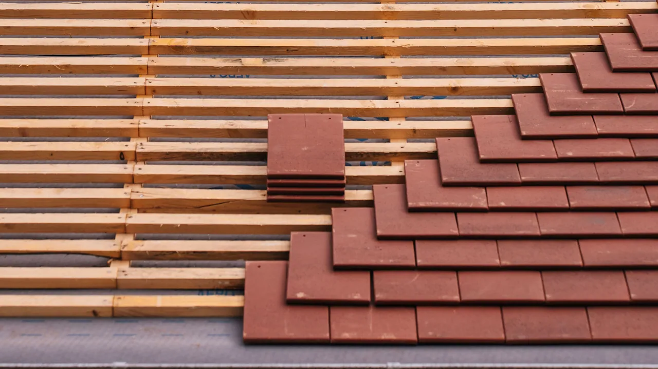 Full re-roof in progress, new tiles being laid
